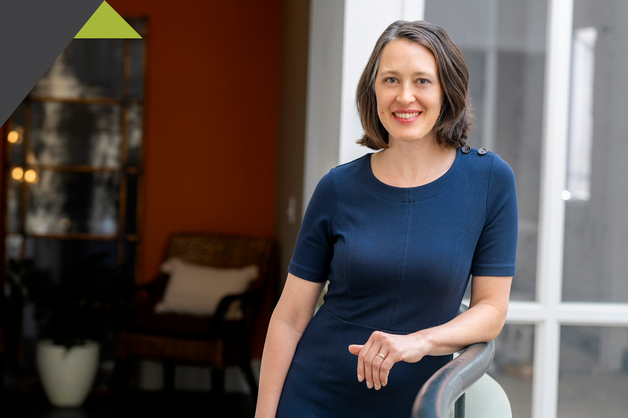Jean Hess leaning next to a banister