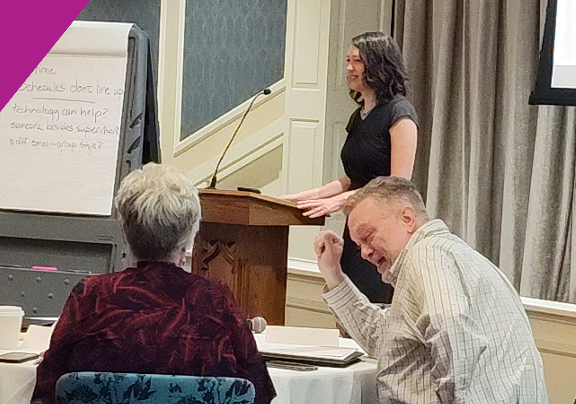 A group of people sitting and listening to Jean speak